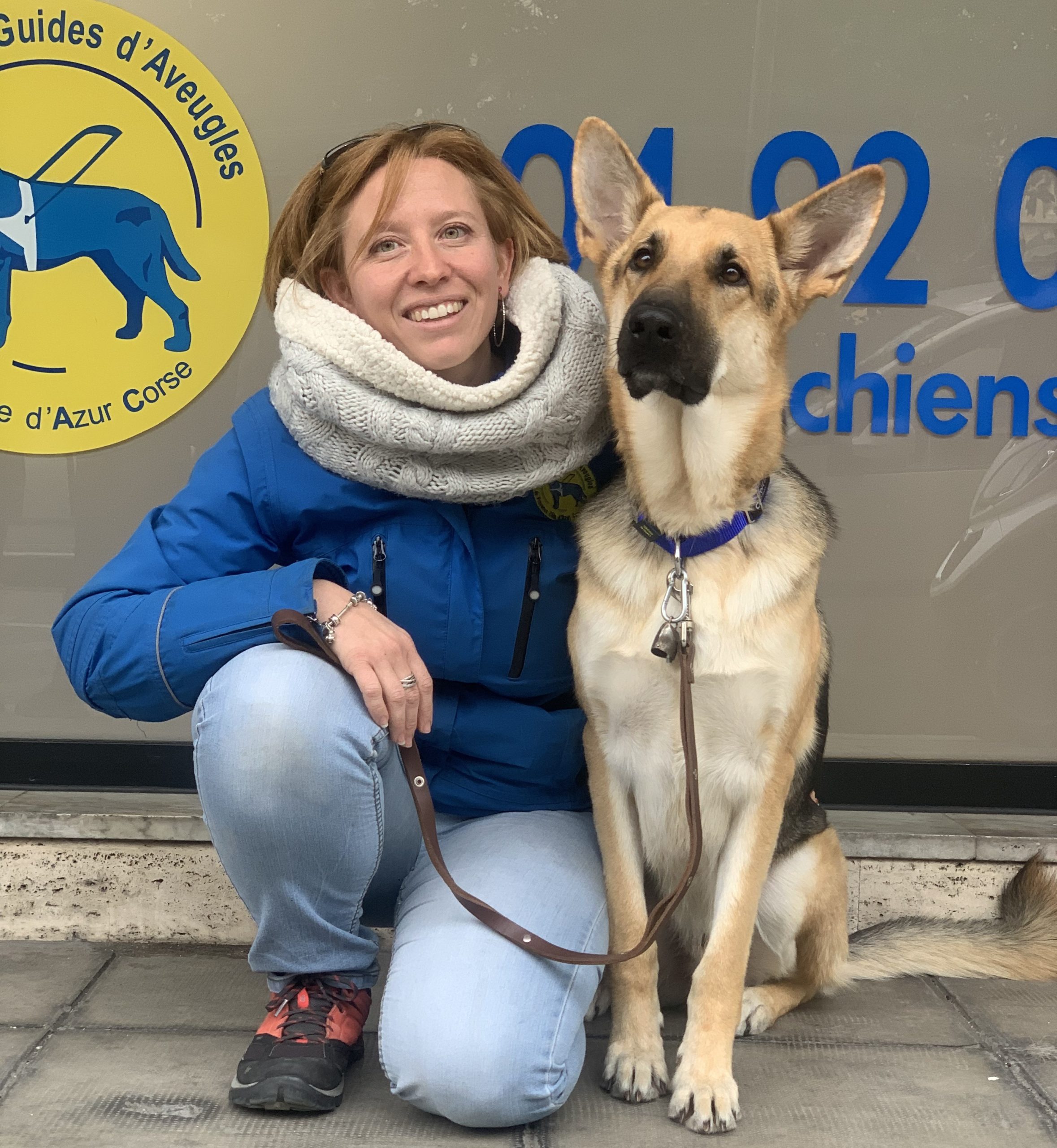 Sandrine Lebreton kneeling next to a german shepherd