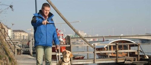 A man on a walk with his guide dog